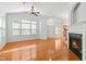 Open-concept living room with bright natural light, hardwood floors, and a fireplace at 13338 Ashford Park Dr, Raleigh, NC 27613