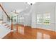 Bright living room with hardwood floors, large windows, and stairs leading to the upper level at 13338 Ashford Park Dr, Raleigh, NC 27613