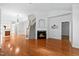 Spacious living room features a fireplace, hardwood floors, and stairs leading to the second floor at 13338 Ashford Park Dr, Raleigh, NC 27613
