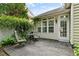 Cozy patio with two chairs, a table, and lush greenery at 13338 Ashford Park Dr, Raleigh, NC 27613