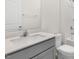 Bathroom featuring a light gray vanity with quartz countertop and a white framed mirror at 138 Fair Child Rd, Spring Lake, NC 28390