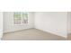 Bedroom featuring neutral carpeting and white walls, and a large window at 138 Fair Child Rd, Spring Lake, NC 28390