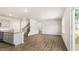 Open concept living room with wood-look flooring, staircase, kitchen and patio access at 138 Fair Child Rd, Spring Lake, NC 28390