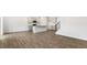 Spacious living room featuring modern wood floors, an island kitchen, and a staircase with carpet at 138 Fair Child Rd, Spring Lake, NC 28390