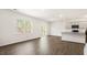 Bright living room with wood floors, large window and open to the kitchen with stainless steel appliances at 138 Fair Child Rd, Spring Lake, NC 28390