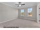 Bedroom with carpet, neutral walls and two windows at 141 Pearl St # 9, Garner, NC 27529