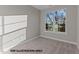 Small room features carpet, neutral walls, white trim and a window at 141 Pearl St # 9, Garner, NC 27529