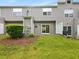Backyard with patio, lawn, fence, landscaping, and view of the upper floors and windows at 1605 Grace Point Rd, Morrisville, NC 27560