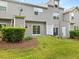 A well-maintained townhouse backyard with a grassy lawn, patio, and exterior access; perfect for outdoor living at 1605 Grace Point Rd, Morrisville, NC 27560