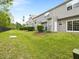 Spacious backyard with lush green grass, privacy shrubs, and access doors offers a serene outdoor retreat at 1605 Grace Point Rd, Morrisville, NC 27560
