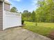 A partially fenced backyard with grass and trees at 1605 Grace Point Rd, Morrisville, NC 27560