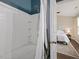 Bathroom showcasing white tile shower with built-in shelving, and view into the bedroom at 1605 Grace Point Rd, Morrisville, NC 27560