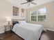 Bedroom with hardwood floors, a ceiling fan, and large window offering ample natural light at 1605 Grace Point Rd, Morrisville, NC 27560