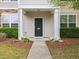 Close-up of a well-maintained front exterior with a blue door and manicured landscaping at 1605 Grace Point Rd, Morrisville, NC 27560