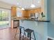 Bright kitchen featuring stainless steel appliances, granite counters, and breakfast bar area at 1605 Grace Point Rd, Morrisville, NC 27560
