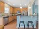 Well-equipped kitchen with stainless steel appliances, wood cabinetry, and breakfast bar seating at 1605 Grace Point Rd, Morrisville, NC 27560
