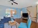 Cozy living room with blue walls, hardwood floors, and stairs to the second floor at 1605 Grace Point Rd, Morrisville, NC 27560