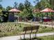 Community playground featuring shade structures, play equipment, and accessible walking paths with seating at 1605 Grace Point Rd, Morrisville, NC 27560