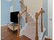 Carpeted staircase with light blue walls and dark wood banister at 1605 Grace Point Rd, Morrisville, NC 27560