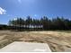 Expansive backyard with trees, blue sky, and grass; perfect for outdoor activities at 172 Knoll Way, Sanford, NC 27332
