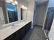 New bathroom with double sink vanity, dark cabinets, and tiled shower at 172 Knoll Way, Sanford, NC 27332