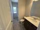 New bathroom with wood vanity, light countertop, and shower/tub at 172 Knoll Way, Sanford, NC 27332