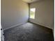 Bright bedroom featuring soft carpeting and a window, creating a serene atmosphere at 172 Knoll Way, Sanford, NC 27332