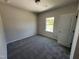 Carpeted bedroom with a window and neutral paint, offering a cozy and bright space at 172 Knoll Way, Sanford, NC 27332