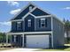 Charming two-story home with blue siding, white trim, and a welcoming two-car garage at 172 Knoll Way, Sanford, NC 27332