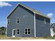 Two-story home showcasing a modern exterior with blue siding, white trim, and well-placed windows at 172 Knoll Way, Sanford, NC 27332