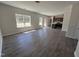 Open-concept living room with hardwood floors and ample natural light, flowing into the kitchen at 172 Knoll Way, Sanford, NC 27332