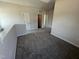 Open loft area with plush carpeting, offering versatile space and access to multiple rooms at 172 Knoll Way, Sanford, NC 27332