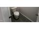 New powder room with neutral walls and gray tile floor at 172 Knoll Way, Sanford, NC 27332