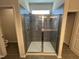 New bathroom with standing tiled shower behind glass doors at 172 Knoll Way, Sanford, NC 27332