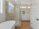 Modern bathroom with freestanding tub, glass shower, and stylish tile accents at 1724 Deacon Falls Way, Wendell, NC 27591