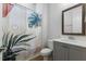 Bathroom featuring vanity with gray cabinets, modern faucet and monstera leaf shower curtain at 1724 Deacon Falls Way, Wendell, NC 27591
