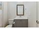 This bathroom features a modern vanity with gray cabinets, white countertop, and framed mirror at 1724 Deacon Falls Way, Wendell, NC 27591