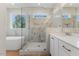 Bright bathroom with glass shower, soaking tub, wood tile floors, and double sink vanity at 1724 Deacon Falls Way, Wendell, NC 27591