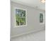 Sunlit bedroom with views of the trees from two windows at 1724 Deacon Falls Way, Wendell, NC 27591