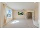 Spacious bedroom with natural light, plush carpet, and access to additional rooms at 1724 Deacon Falls Way, Wendell, NC 27591
