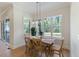 Open breakfast nook with wood table, large window, and sliding glass doors at 1724 Deacon Falls Way, Wendell, NC 27591