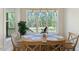 Bright breakfast nook features wood table, chairs, and expansive window views at 1724 Deacon Falls Way, Wendell, NC 27591