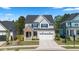 Charming two-story home featuring a brick entryway, white siding, and a well-maintained lawn at 1724 Deacon Falls Way, Wendell, NC 27591