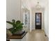 Bright foyer with wood floors, modern lighting, and a view of the front door at 1724 Deacon Falls Way, Wendell, NC 27591