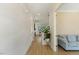 Bright hallway with wood floors leading to an open living space and staircase at 1724 Deacon Falls Way, Wendell, NC 27591