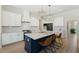 Open kitchen with granite counters, island with seating, and stainless steel appliances at 1724 Deacon Falls Way, Wendell, NC 27591