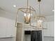Close-up of modern hanging kitchen lighting at 1724 Deacon Falls Way, Wendell, NC 27591