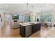 Open floor plan kitchen with a view of the living room and fireplace at 1724 Deacon Falls Way, Wendell, NC 27591