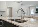 Close-up of island with granite countertop and stainless steel faucet and sink at 1724 Deacon Falls Way, Wendell, NC 27591