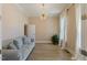 Cozy living room with hardwood floors, neutral walls, and a stylish light fixture at 1724 Deacon Falls Way, Wendell, NC 27591